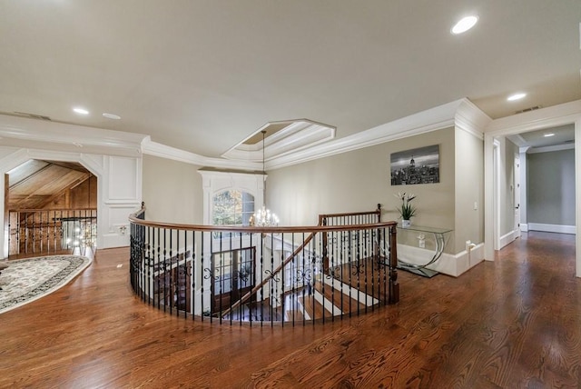 corridor featuring crown molding, hardwood / wood-style floors, and an inviting chandelier