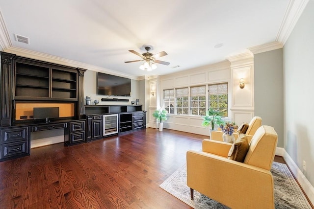 living room with ceiling fan, ornamental molding, and dark wood-type flooring