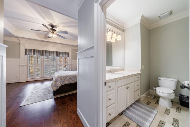 bathroom featuring vanity, ceiling fan, crown molding, hardwood / wood-style flooring, and toilet