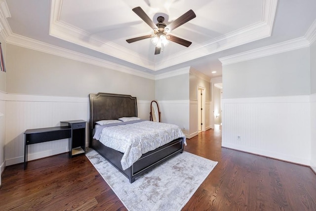 bedroom with a tray ceiling, ceiling fan, dark hardwood / wood-style flooring, and ornamental molding