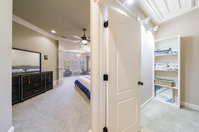 interior space with ceiling fan and ornamental molding