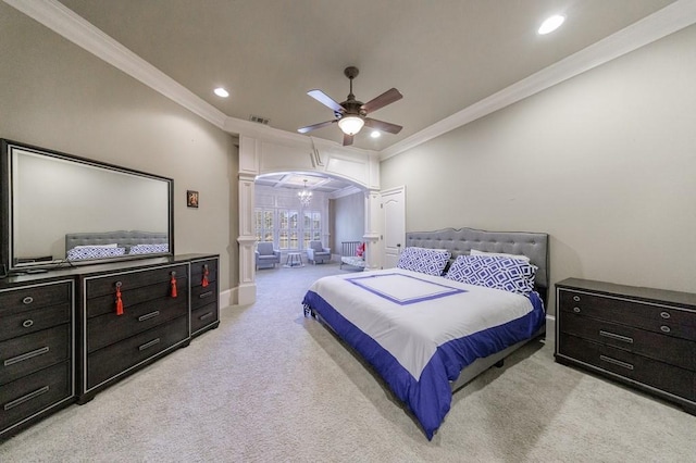 carpeted bedroom featuring decorative columns, ceiling fan, and crown molding