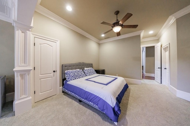 bedroom with ceiling fan, light colored carpet, and crown molding