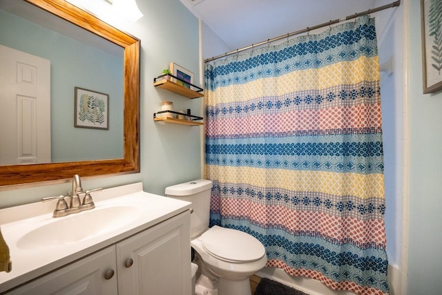 bathroom featuring vanity, toilet, and walk in shower