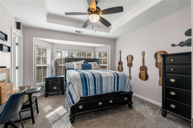 bedroom featuring crown molding, ceiling fan, carpet flooring, and a raised ceiling