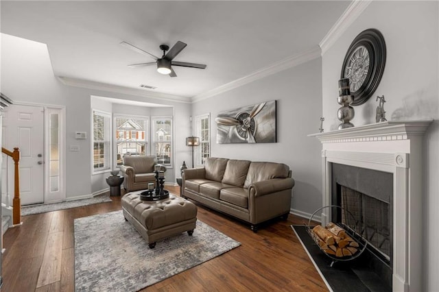 living room with ceiling fan, ornamental molding, and dark hardwood / wood-style floors