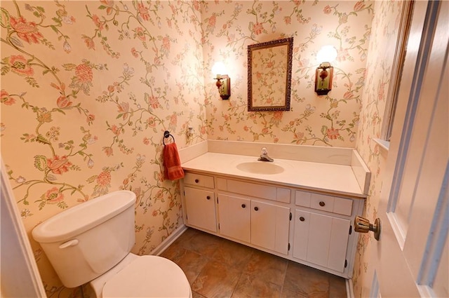 bathroom with toilet and vanity