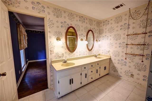 bathroom with vanity, hardwood / wood-style flooring, and crown molding