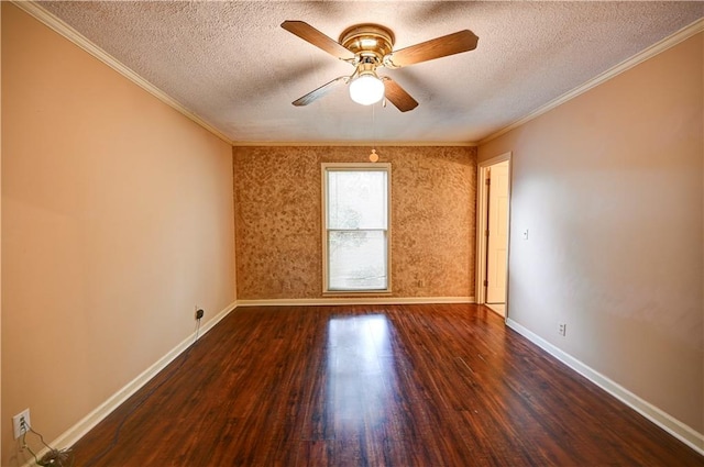 spare room with ceiling fan, a textured ceiling, dark hardwood / wood-style flooring, and crown molding