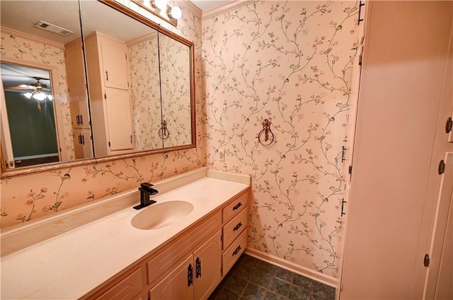 bathroom featuring ceiling fan, vanity, and crown molding