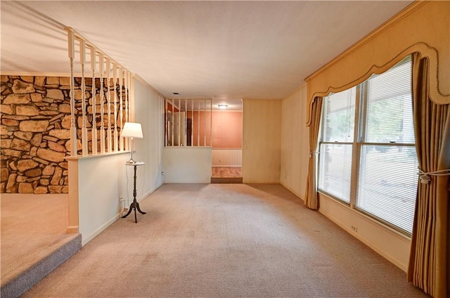 unfurnished room featuring light carpet and crown molding