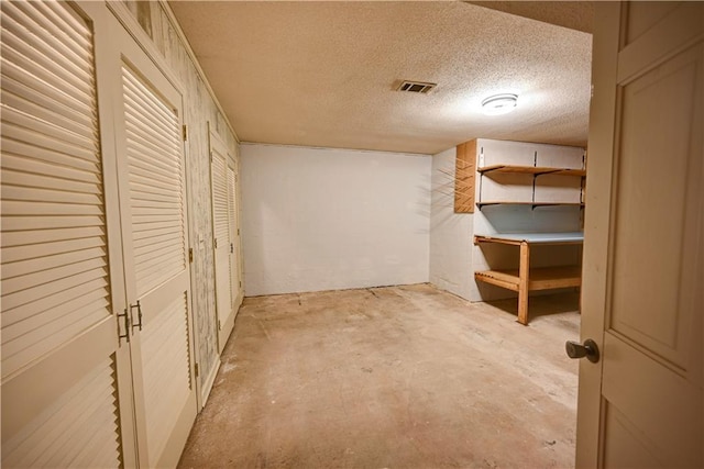 basement featuring a textured ceiling