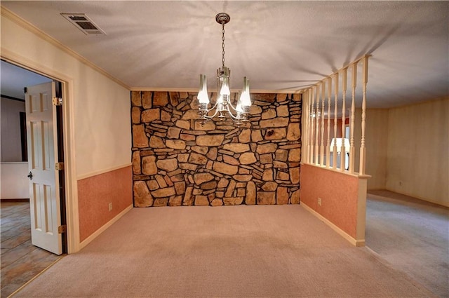 unfurnished dining area with carpet, an inviting chandelier, and crown molding