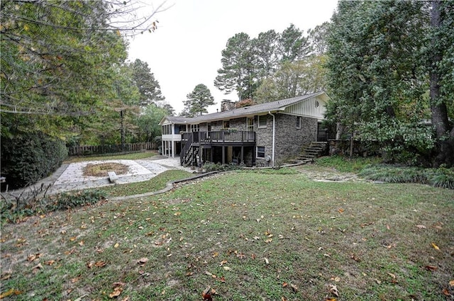 view of yard with a wooden deck and a patio area