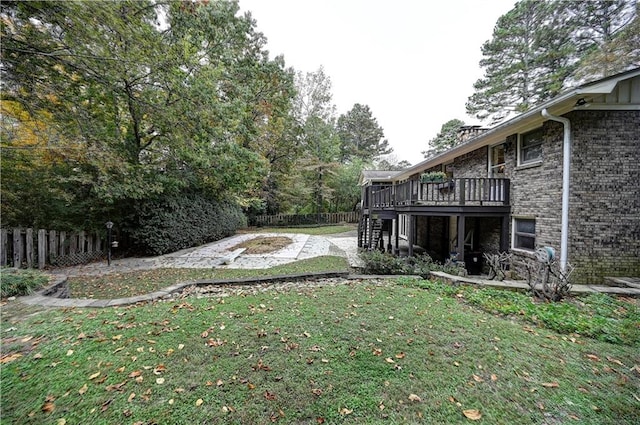 view of yard featuring a wooden deck and a patio area