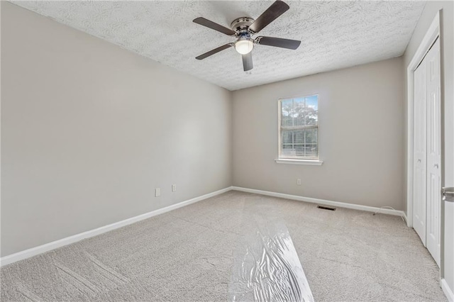 4200 Sterling Pointe Dr, Douglasville, GA 30135 - unfurnished bedroom with carpet flooring, a closet, a textured ceiling, and baseboards