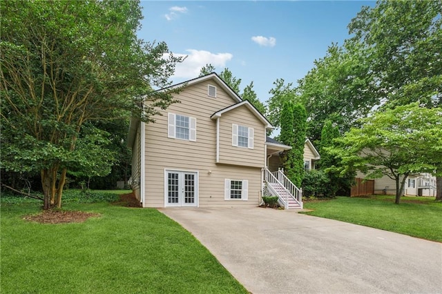 4200 Sterling Pointe Dr, Douglasville, GA 30135 - tri-level home with french doors, driveway, a front lawn, and stairway