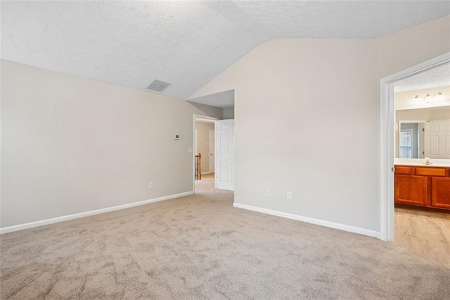 2040 Village Green Dr, Fairburn, GA 30213 - unfurnished room with lofted ceiling, light carpet, and a textured ceiling