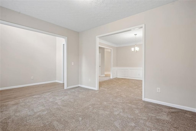 2040 Village Green Dr, Fairburn, GA 30213 - spare room featuring carpet flooring, a textured ceiling, and a chandelier