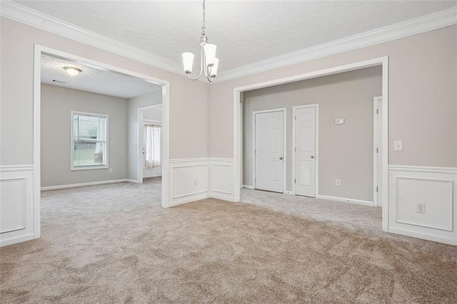 2040 Village Green Dr, Fairburn, GA 30213 - unfurnished room with a chandelier, carpet flooring, ornamental molding, a wainscoted wall, and a decorative wall