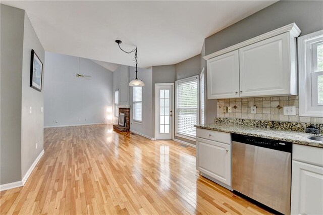 kitchen with ceiling fan, backsplash, dishwasher, light wood-style flooring, and white cabinetry