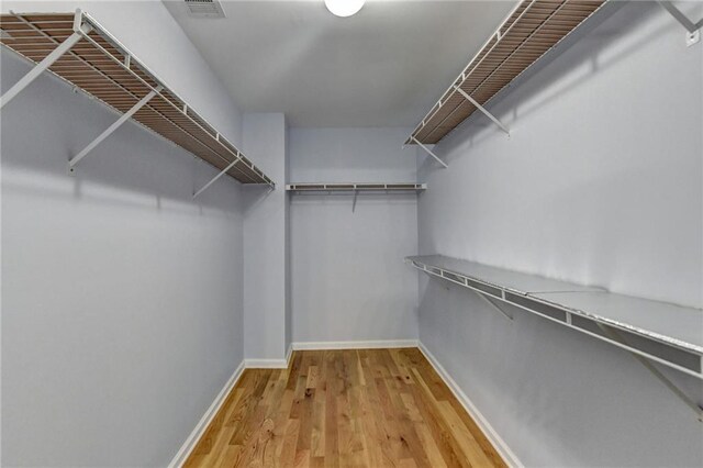spacious closet with wood finished floors and visible vents