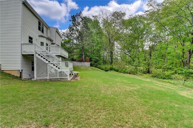 view of yard featuring a deck and stairs