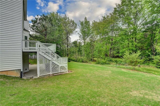 view of yard featuring a wooden deck and stairs