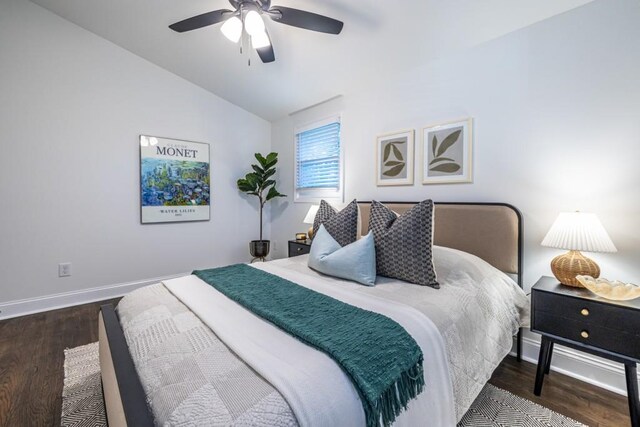 bedroom with ceiling fan, dark hardwood / wood-style floors, and vaulted ceiling