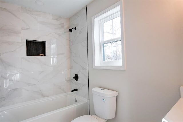 bathroom with a healthy amount of sunlight, toilet, and tiled shower / bath combo