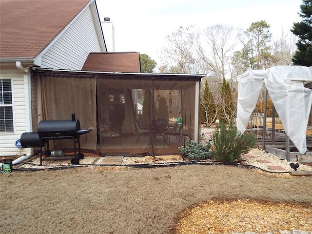 exterior space with a sunroom and a yard