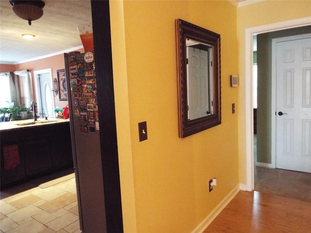 hall with ornamental molding and sink