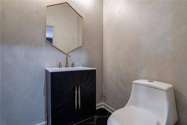 bathroom featuring tile patterned floors, vanity, and toilet