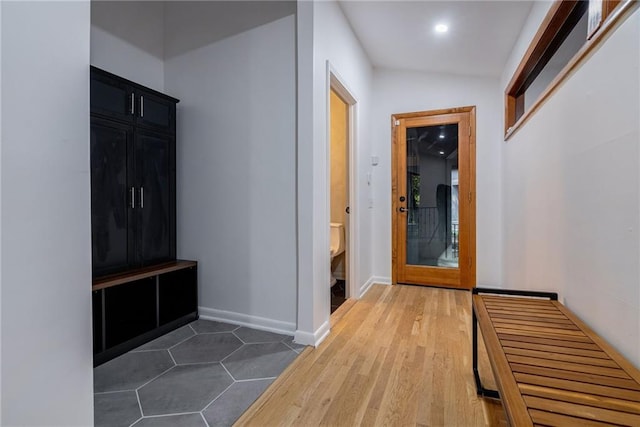 mudroom featuring dark hardwood / wood-style flooring and vaulted ceiling