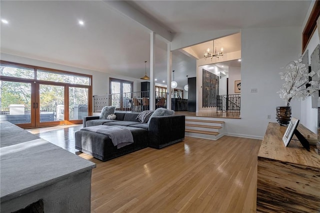 living room with a notable chandelier and hardwood / wood-style flooring