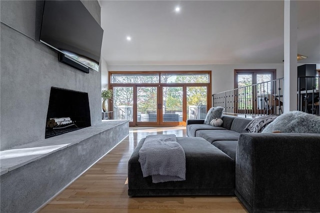 living room with a fireplace and light wood-type flooring