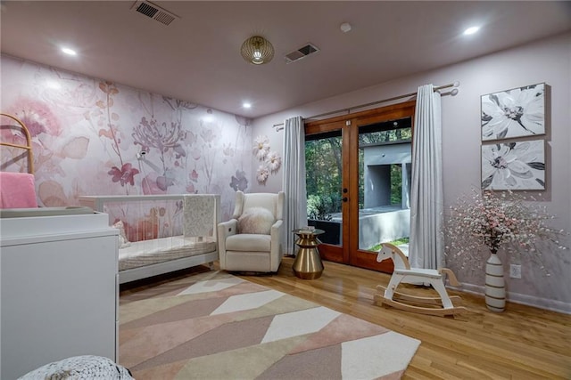 living area featuring light wood-type flooring and french doors