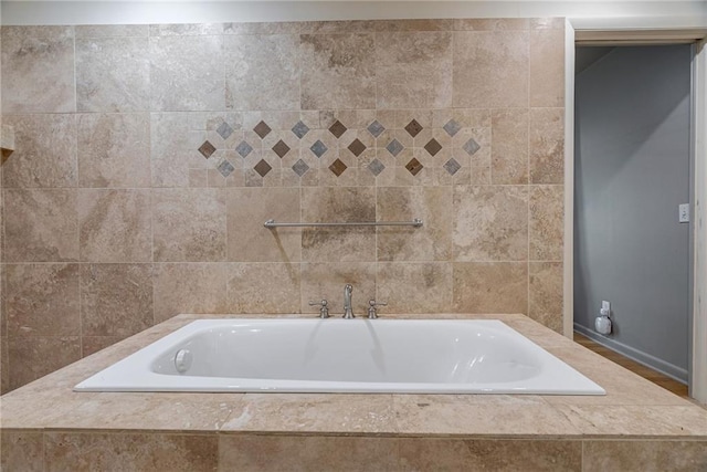 bathroom with tiled tub