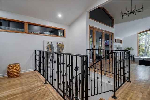 hallway featuring hardwood / wood-style flooring and lofted ceiling