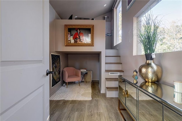 interior space featuring lofted ceiling and hardwood / wood-style flooring