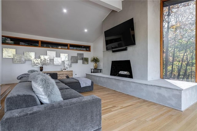 living room featuring hardwood / wood-style floors and lofted ceiling with beams