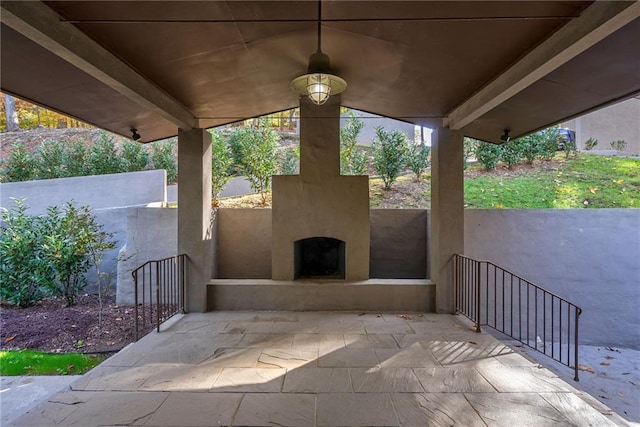 view of patio featuring exterior fireplace