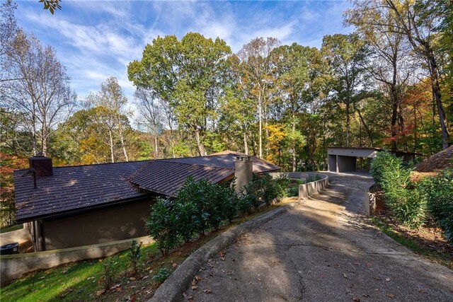 view of property exterior featuring a garage and an outdoor structure