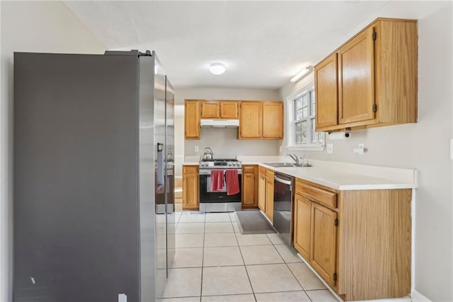 kitchen with appliances with stainless steel finishes, light tile patterned floors, and sink