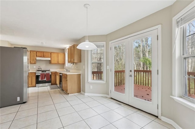 kitchen with french doors, stainless steel appliances, a healthy amount of sunlight, sink, and decorative light fixtures