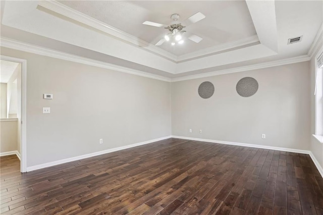 unfurnished room with dark hardwood / wood-style flooring, a raised ceiling, ceiling fan, and crown molding