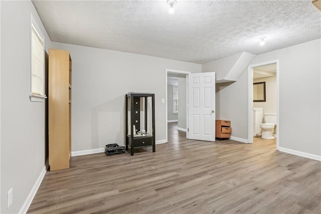 interior space with hardwood / wood-style floors and a textured ceiling