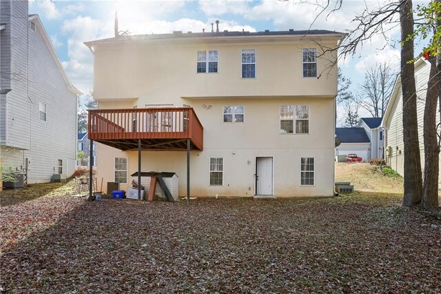 back of property featuring central AC unit and a wooden deck