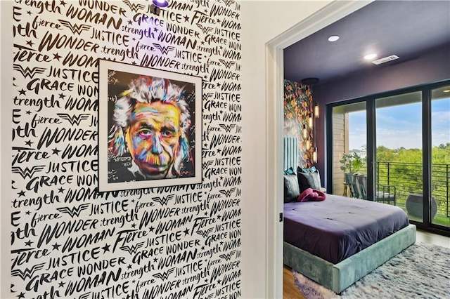 bedroom featuring access to exterior and wood-type flooring