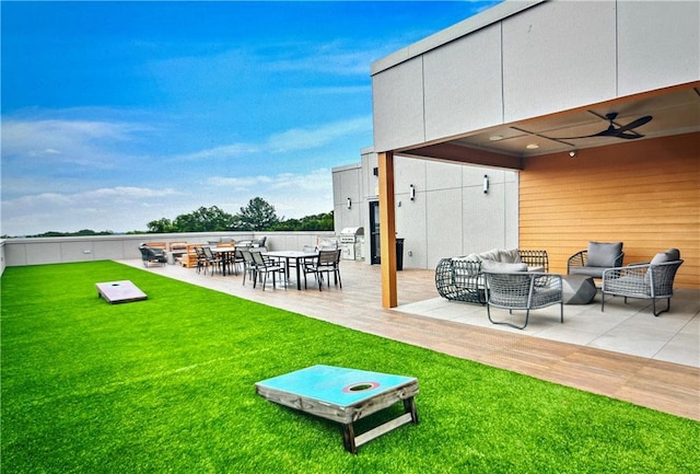 exterior space with a lawn, ceiling fan, a patio area, and an outdoor hangout area